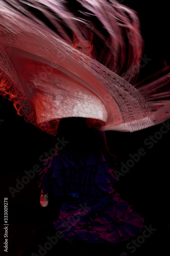 flamenco dancer with her red-lighted manton