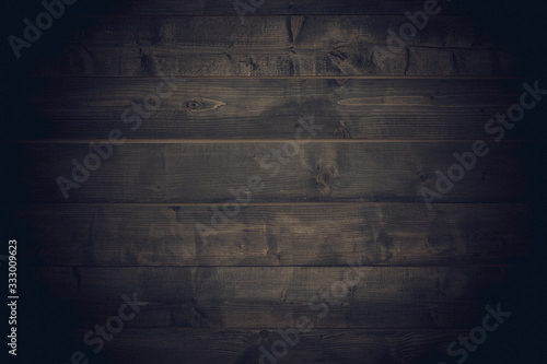 Old brown wood background made of dark natural wood in grunge style. The view from the top. Natural raw planed texture of coniferous pine. The surface of the table to shoot flat lay. Copy space