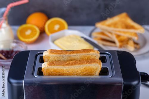 Slices of toast coming out of the toaster for healthy breakfast
