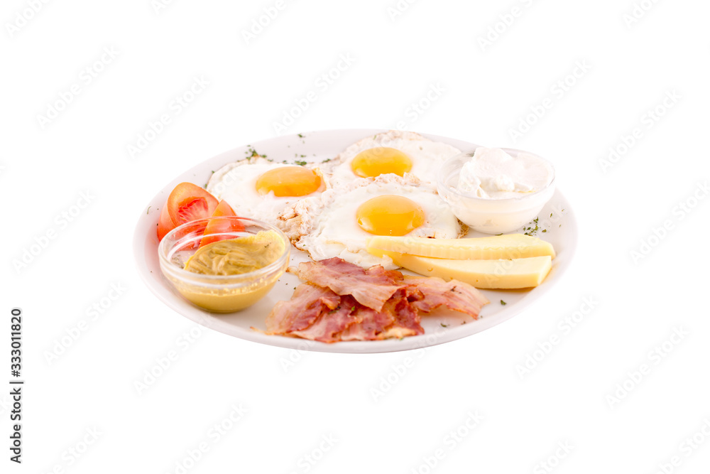 Three fried eggs garnished with cheese, ham and tomatoes. Photo taken on a white background. Dish of Montenegrin cuisine. Suitable for the restaurant menu. Three fried eggs garnished with cheese, ham and tomatoes. Photo taken on a white background. Dish of Montenegrin cuisine. Suitable for the restaurant menu.