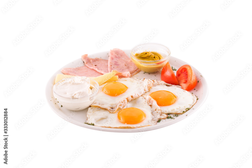 Three fried eggs garnished with cheese, ham and tomatoes. Photo taken on a white background. Dish of Montenegrin cuisine. Suitable for the restaurant menu. Three fried eggs garnished with cheese, ham and tomatoes. Photo taken on a white background. Dish of Montenegrin cuisine. Suitable for the restaurant menu.