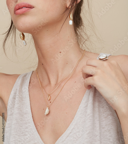 Detail woman wearing shell jewellery photo