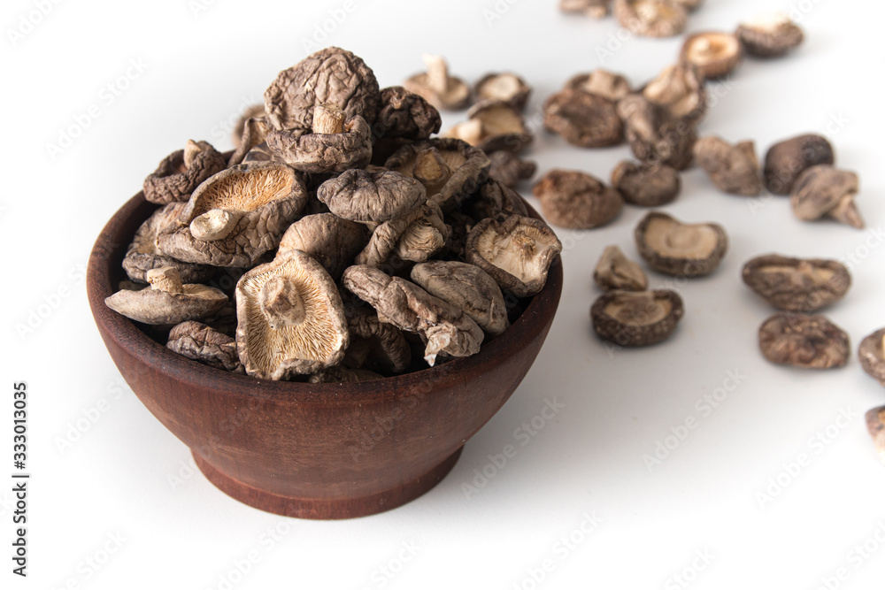 Dried Shitake Mushroom into a wooden bowl Dried Shitake Mushroom into a wooden bowl