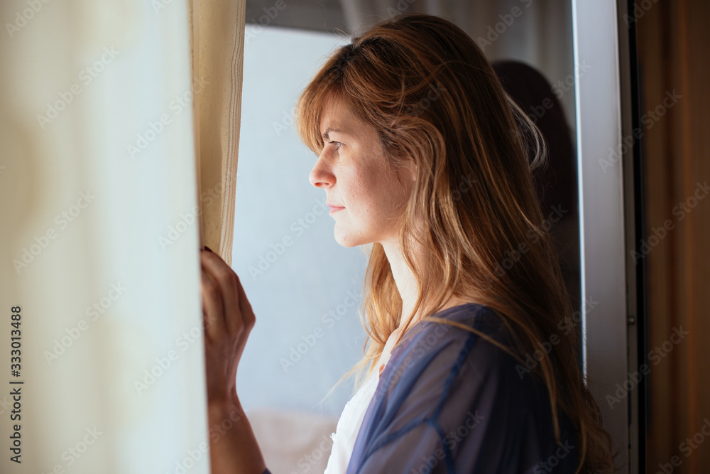 Woman looking through the window Woman looking through the window
