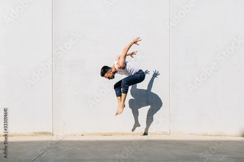 A dancer dancing in front of a concrete wall photo