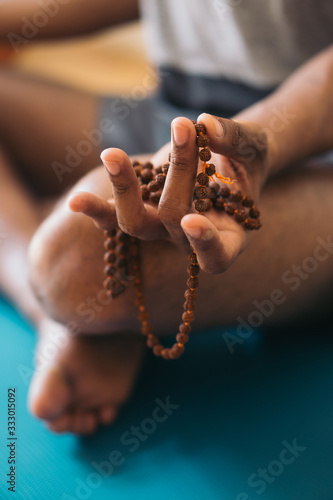 Adult african american man meditating at home photo