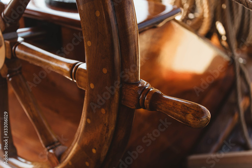 Captains wheel on board a sailboat photo