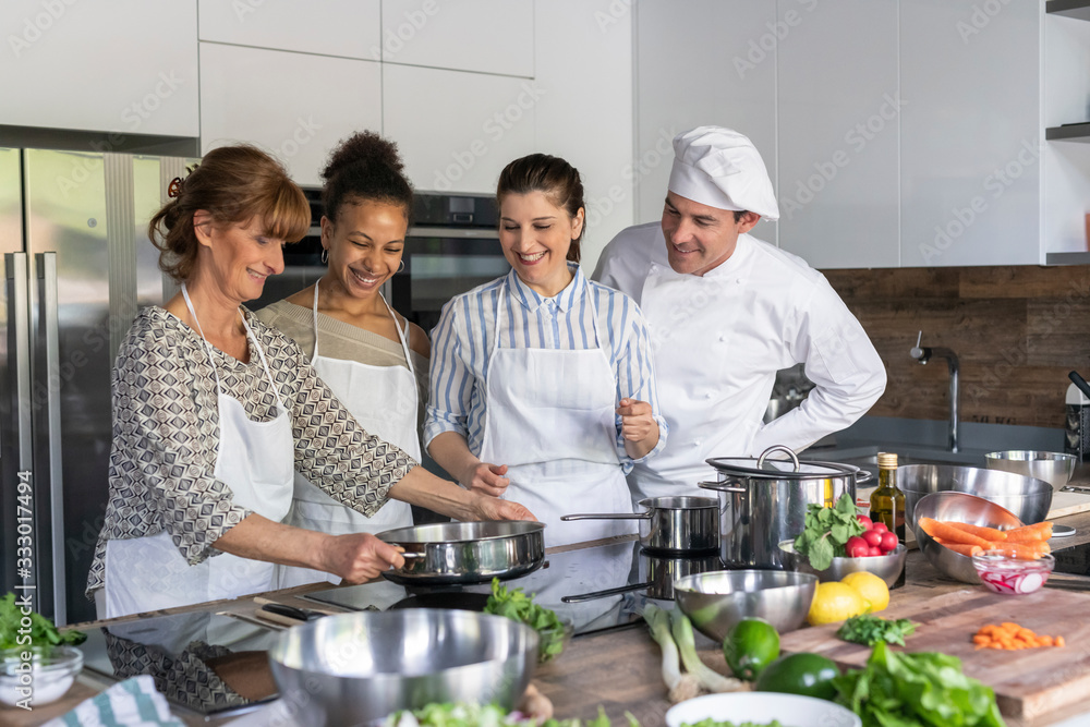 Cookinhg together during a kitchen class Cookinhg together during a kitchen class