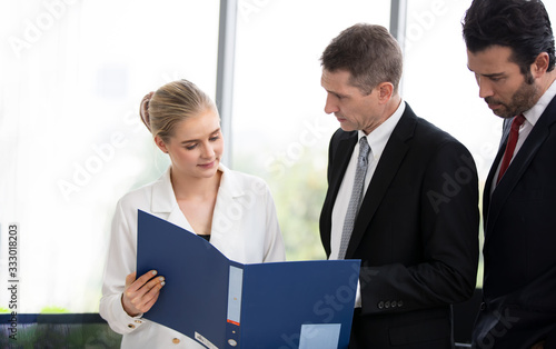 Business woman making a presentation at office. Business executive delivering a presentation to his colleagues during meeting or in-house business training, explaining business plans to his employees.