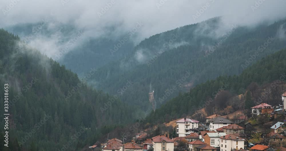 Time lapse of fog and clouds rolling over the mountain snow hills Time lapse of fog and clouds rolling over the mountain snow hills