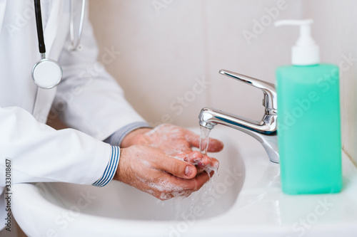 doctor man washing hands with disinfectant soap. Hygiene and Corona virus Covid-19 concept