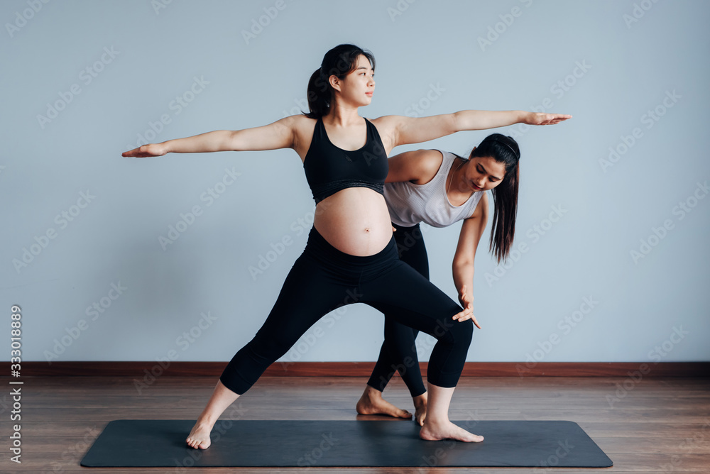 Pregnant woman working with personal trainer Pregnant woman working with personal trainer