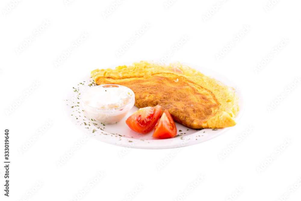 Omelet with cheese, ham or prsut. Served on a white plate, melted on a white background. The photo is suitable for feeding mei restaurant. Dish of Montenegrin cuisine. Omelet with cheese, ham or prsut. Served on a white plate, melted on a white background. The photo is suitable for feeding mei restaurant. Dish of Montenegrin cuisine.
