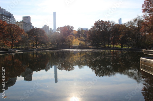 City and Nature reflection at New York City s Central Park lake