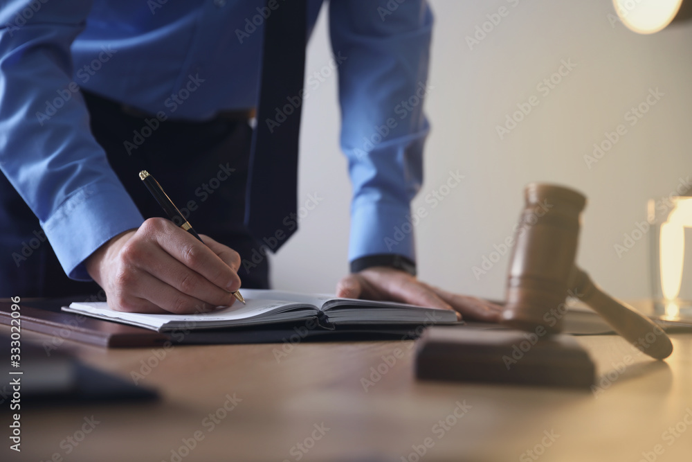 Male lawyer working at table in office, closeup Male lawyer working at table in office, closeup