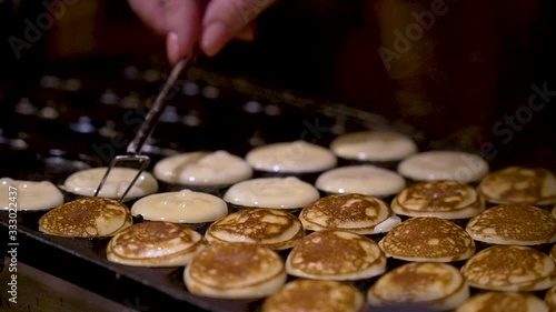 Baking little pancakes on New Year's Square in Tallinn