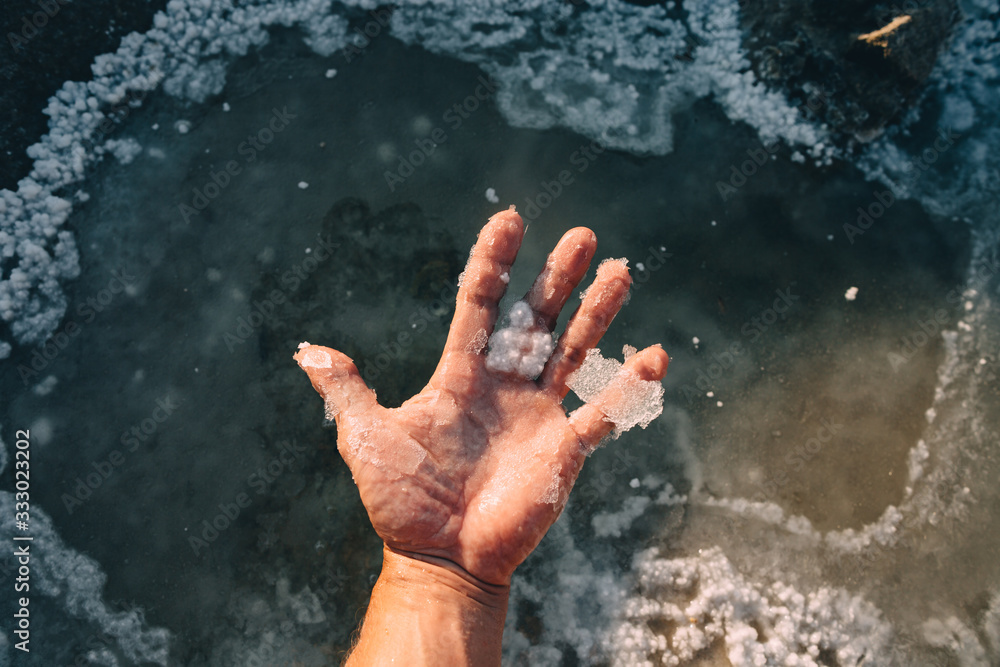 © Evgenij Yulkin/Stocksy - Salt flakes on the palm