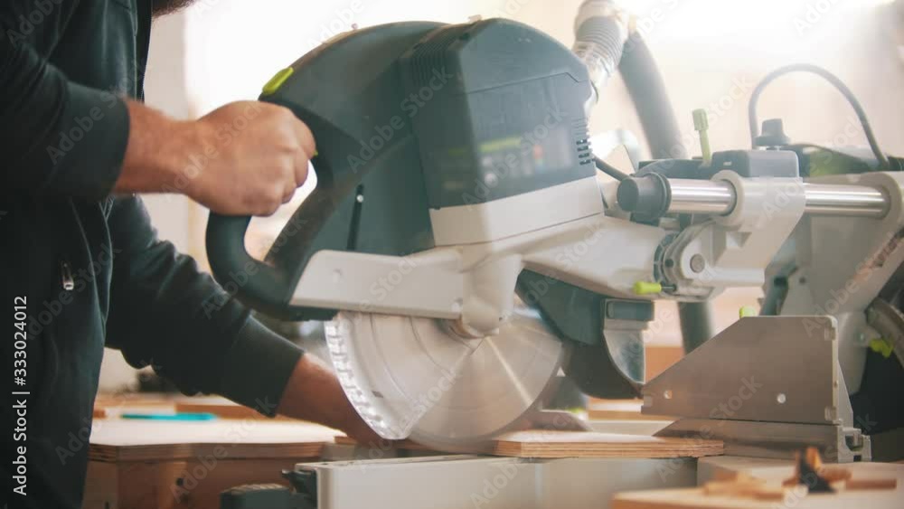 Carpentry working - cutting the plywood using circular saw Carpentry working - cutting the plywood using circular saw