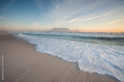 Wide angle view of Table Mountain, one of the natural seven wonders of the world, as seen from Blouberg Beach in Cape Town South Africa