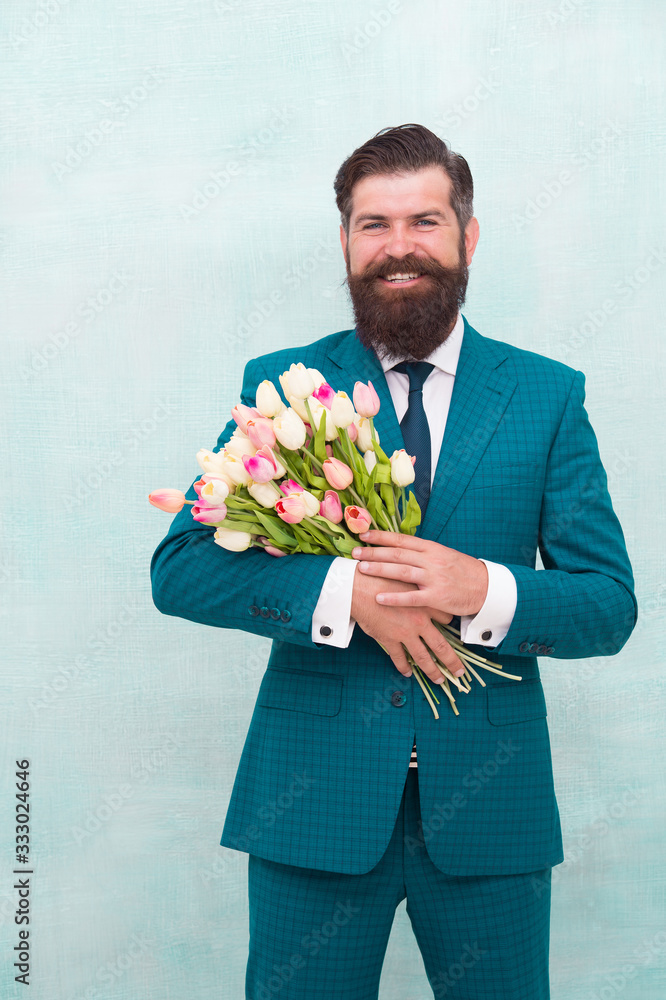 confident businessman hold flowers gift. happy man ready for love date. valentines day holiday. spring is here. for my mother at mothers day. happy womans day. celebrate birthday party confident businessman hold flowers gift. happy man ready for love date. valentines day holiday. spring is here. for my mother at mothers day. happy womans day. celebrate birthday party