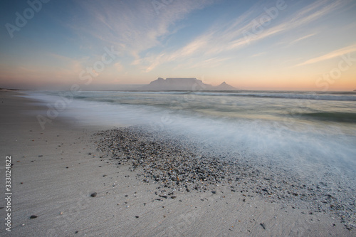 Wide angle view of Table Mountain, one of the natural seven wonders of the world, as seen from Blouberg Beach in Cape Town South Africa