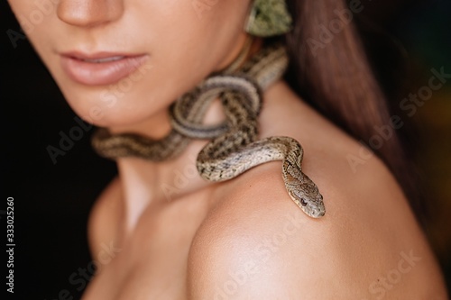 Crop shot of neck with snake, shoulder and lips
