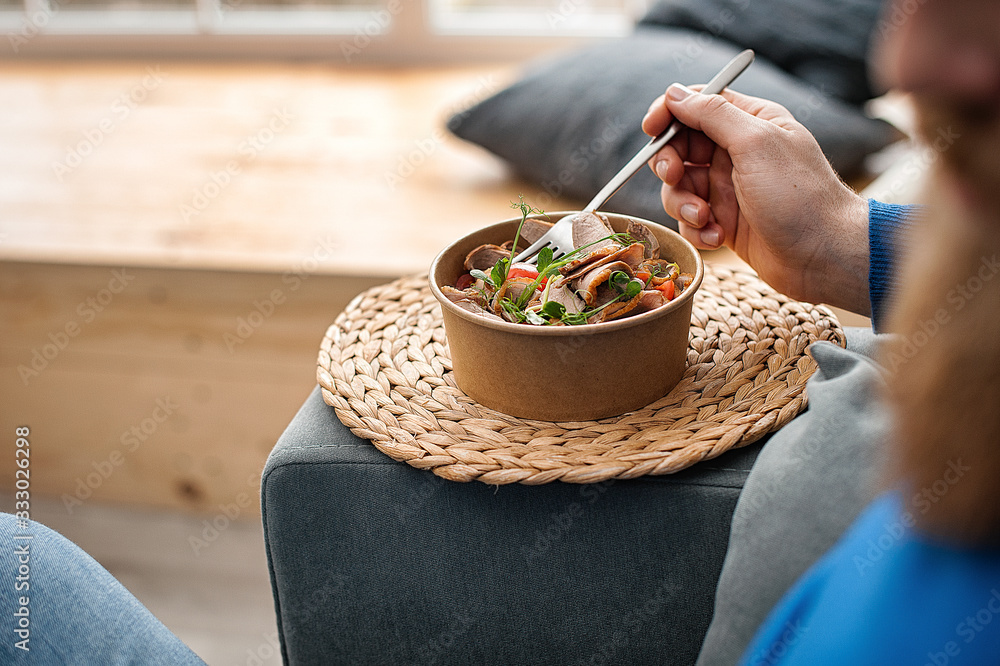 Man Eating Healthy Food On Sofa At Home