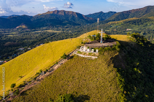 The sign of the city of Coron is on a hill, a famous tourist place. © Song Heming/Stocksy