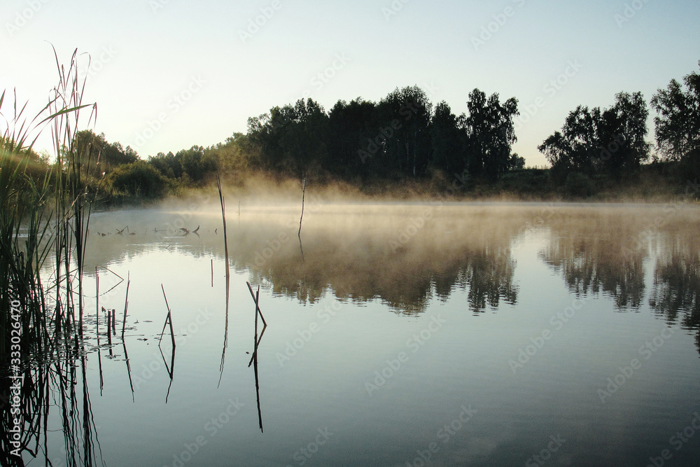 Fototapeta premium Sunrise at river with morning fog Siberia Russia