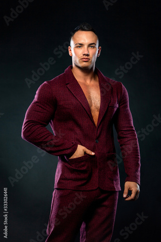 Portrait of handsome stylish man bodybuilder with naked torso in elegant suit © Mike Orlov