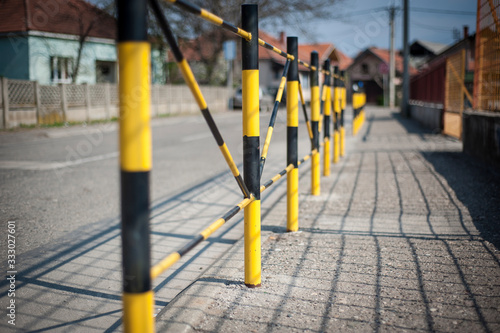 Protective yellow fence for pedestrians in front of the school