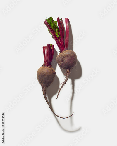 Two Trimmed beets on white photo