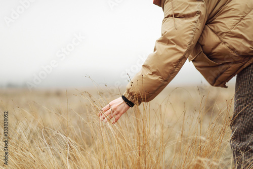 Unrecognizable female hands in autumn grass photo