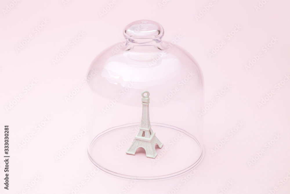 Paris in quarantine coronavirus covid-19 isolation abstract made of Eiffel Tower covered with glass cover. Paris in quarantine coronavirus covid-19 isolation abstract made of Eiffel Tower covered with glass cover.