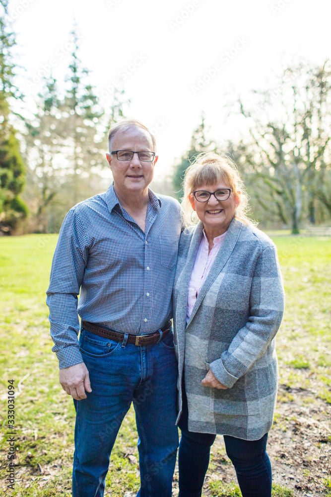 Portrait of happy elderly couple in a park setting. Portrait of happy elderly couple in a park setting.