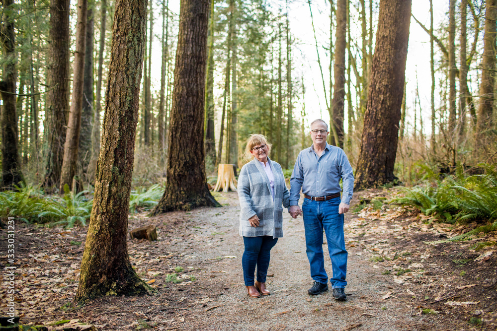 Elderly couple holding hands in the forest. Elderly couple holding hands in the forest.