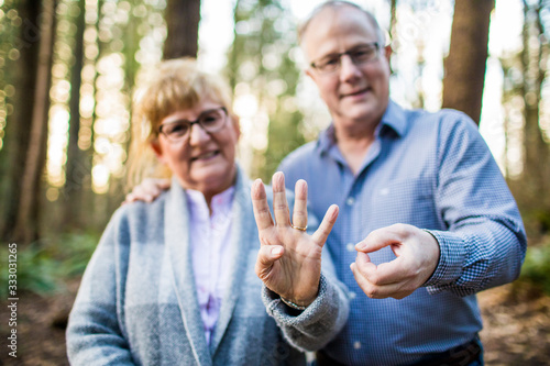 older couple hold out 40 with fingers during 40th anniversary photo