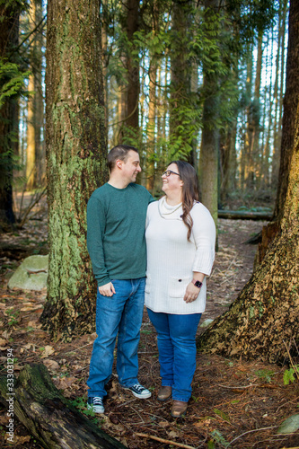 Cute couple laughing, looking at one another. photo