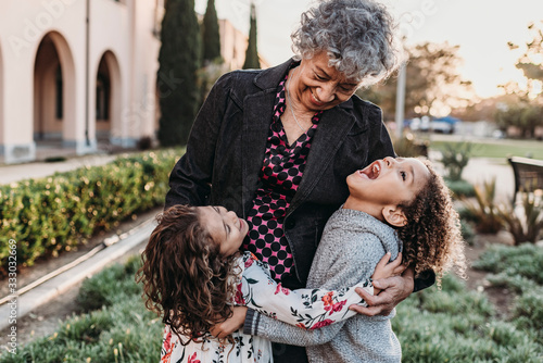Close up lifestyle image of grandmother and grandchildren laughing photo