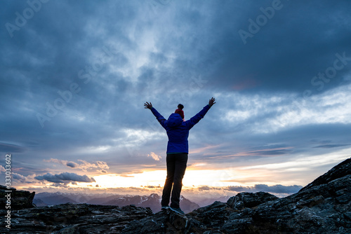 Figure at sunset overlooking the mountains, Southern Alps New Zeala photo