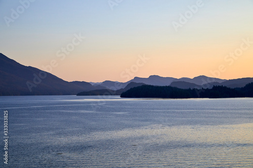 Photography Sun raising over Ketchikan Alaska soft tree lined mountains in the background ca