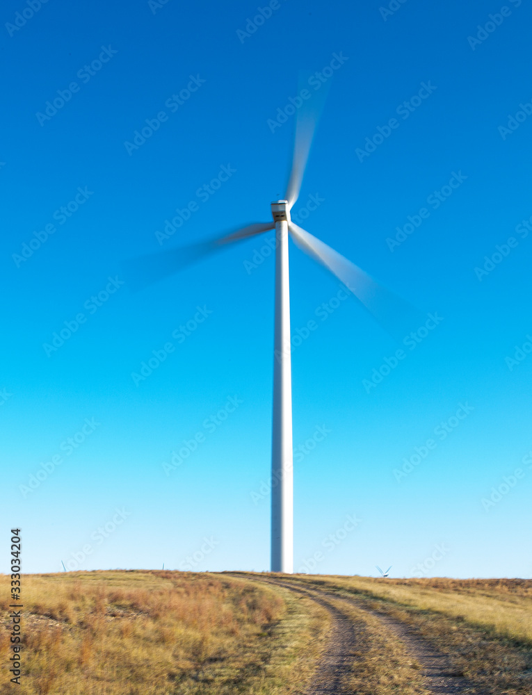 Wind Turbine in motion against blue sky Wind Turbine in motion against blue sky