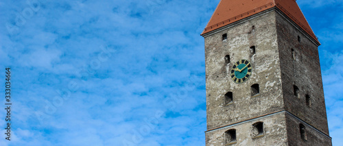 Image of the clock tower against the blue sky. photo