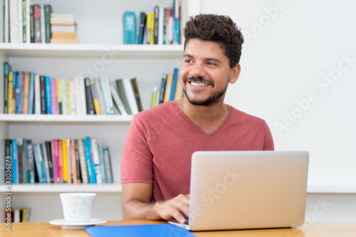 Photographie Attractive latin american man with beard working at computer