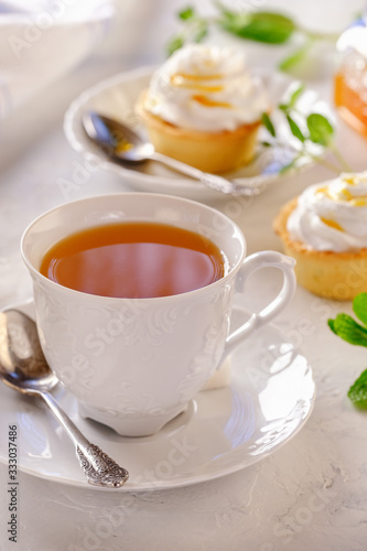 Tartlets with lemon kurd and italian meringue on a white plate