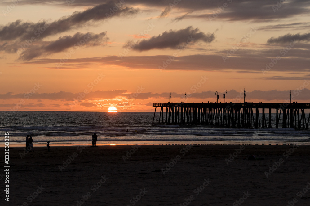 Wonderful view of the sunset and the pier in the city of Pismo Beach, California, USA. Golden hour.