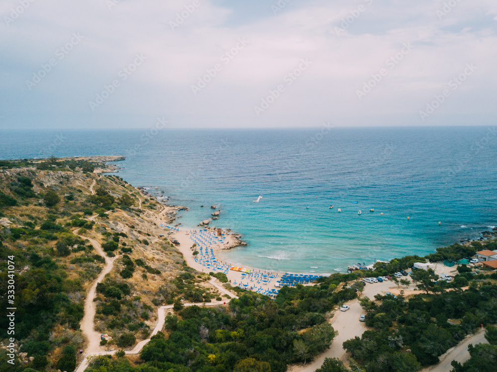 Pissouri. Cyprus Republic. Pissouri beach in a sunny day panorama from a drone.