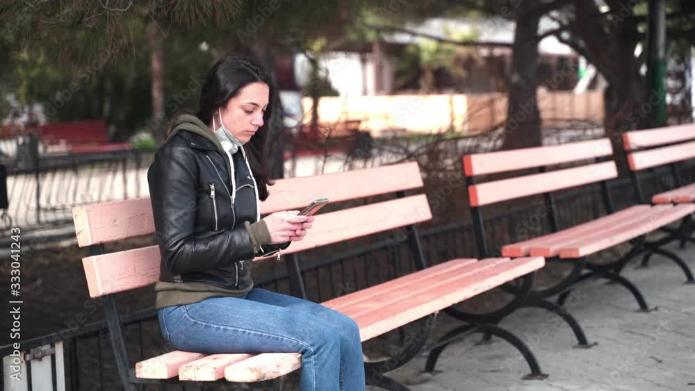 The girl sitting on the bench sit next to a guy and starts coughing. Girl is afraid of contracting a virus. The girl sitting on the bench sit next to a guy and starts coughing. Girl is afraid of contracting a virus.