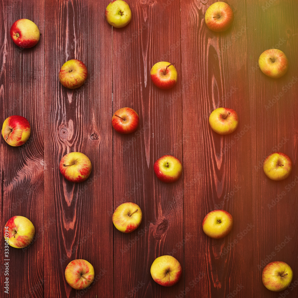 Fresh apples arranged systemically on a wooden background. Fresh apples arranged systemically on a wooden background.