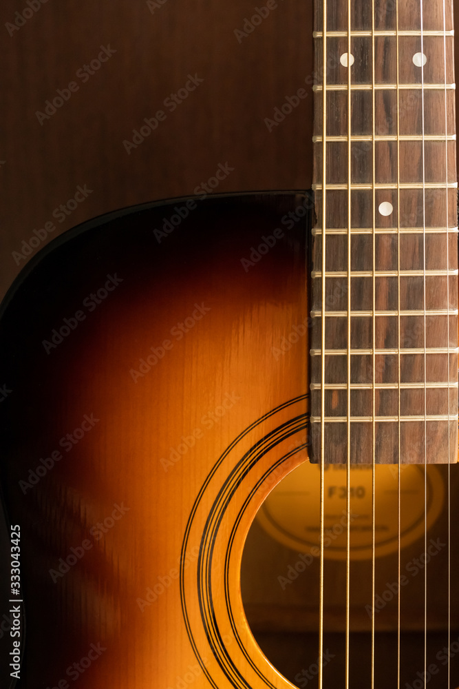 Obraz premium Sound hole of an acoustic guitar, neck, strings, frets, the nut.